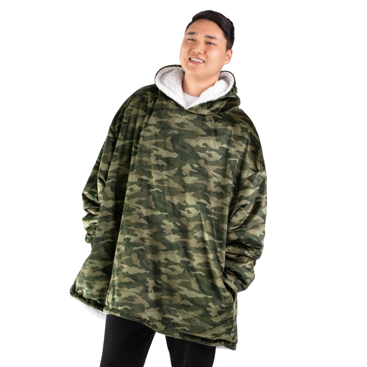 An adult with a sherpa wearable blanket on