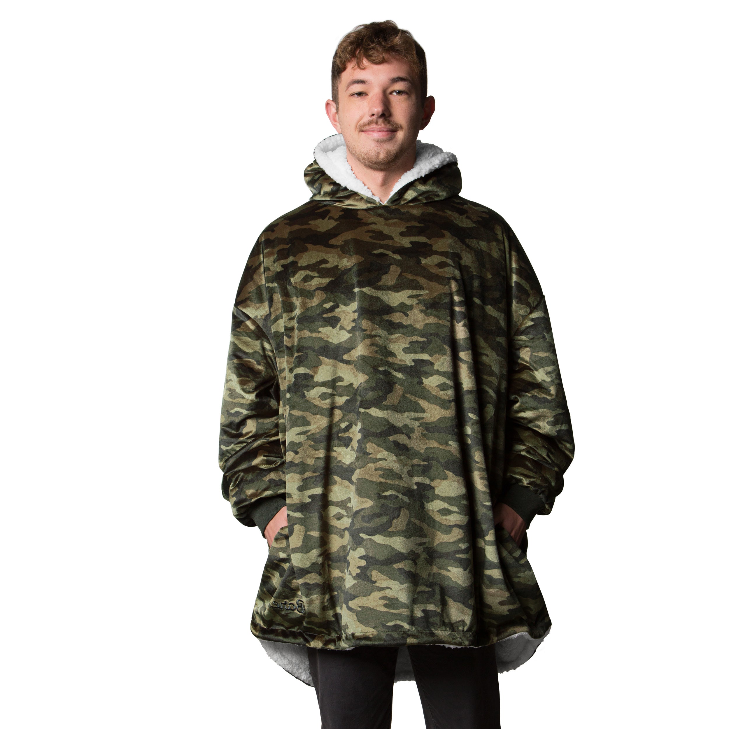 A man is standing while wearing a sherpa wearable blanket