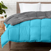 Wooden bed frame with a reversible comforter on the mattress. The comforter is folded back showing the two different colored sides.