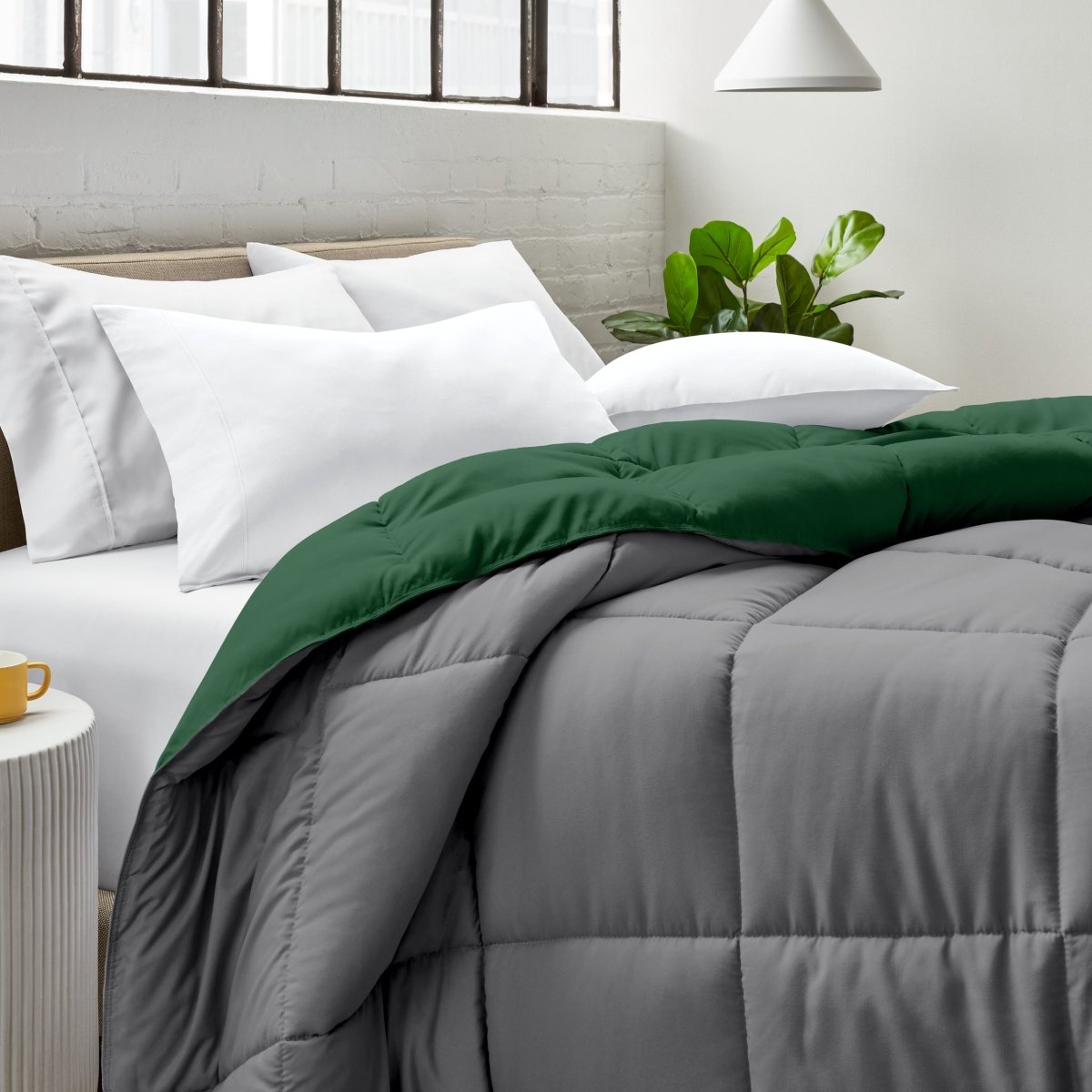 Bed with comforter and white pillows in a bright bedroom setting.