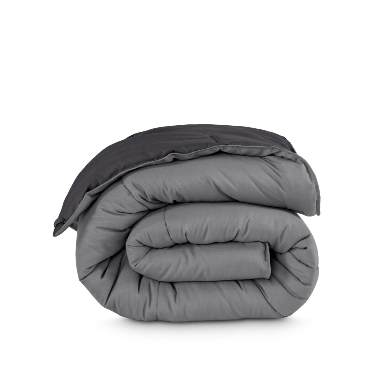 Folded reversible comforter on a white background