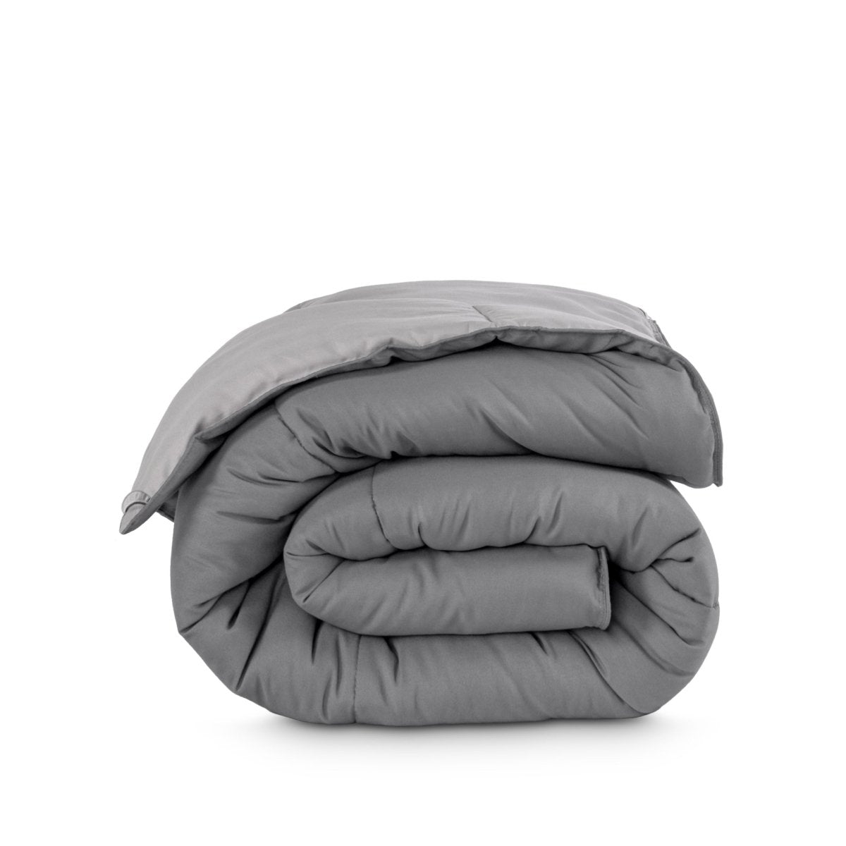 Folded reversible comforter on a white background
