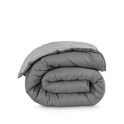 Folded reversible comforter on a white background