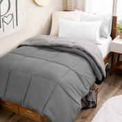 College dorm room with a reversible comforter on the bed