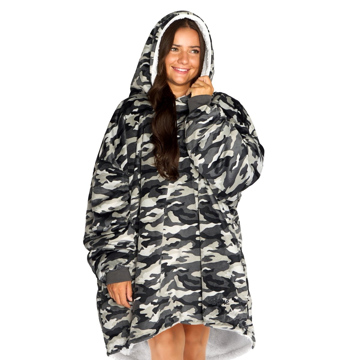 An adult with a sherpa wearable blanket on