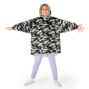 A child wearing a hooded blanket