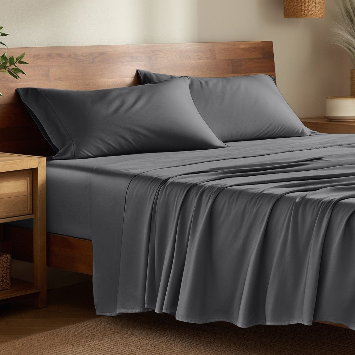 Bamboo bed sheets on a bed in a bedroom with night stands.