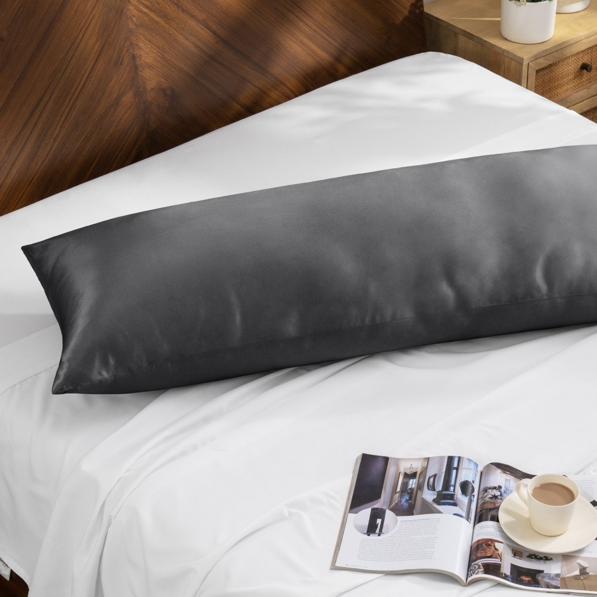 Bamboo pillow on a bed with a magazine and cup of coffee on a wooden nightstand.
