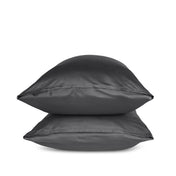 Two grey pillows stacked on a white background