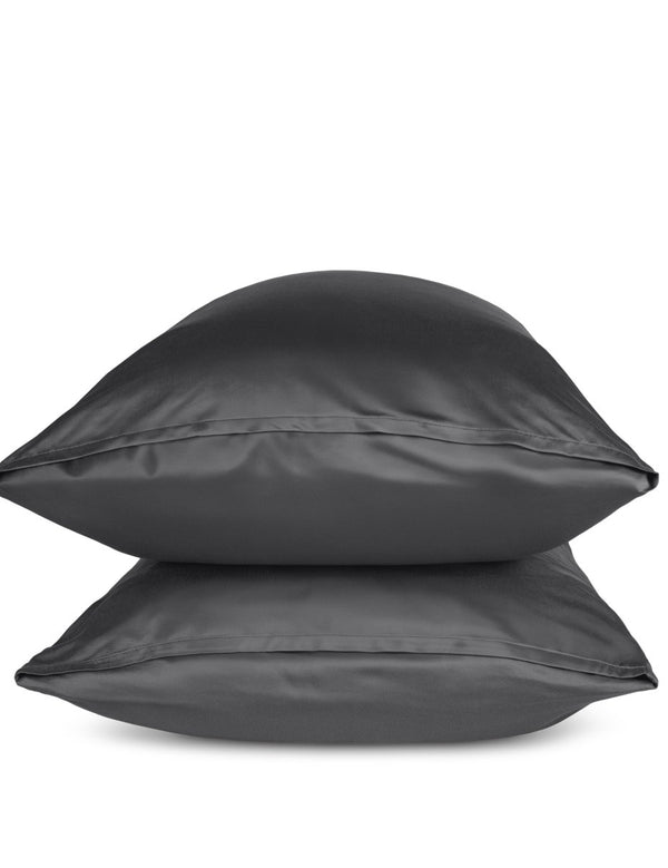 Two grey pillows stacked on a white background