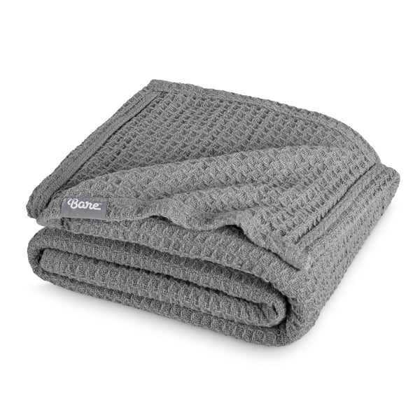 Folded blanket with a Bare Home label on a white background