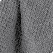 Close up of the fabric of a cotton waffle blanket