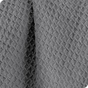 Close up of the fabric of a cotton waffle blanket