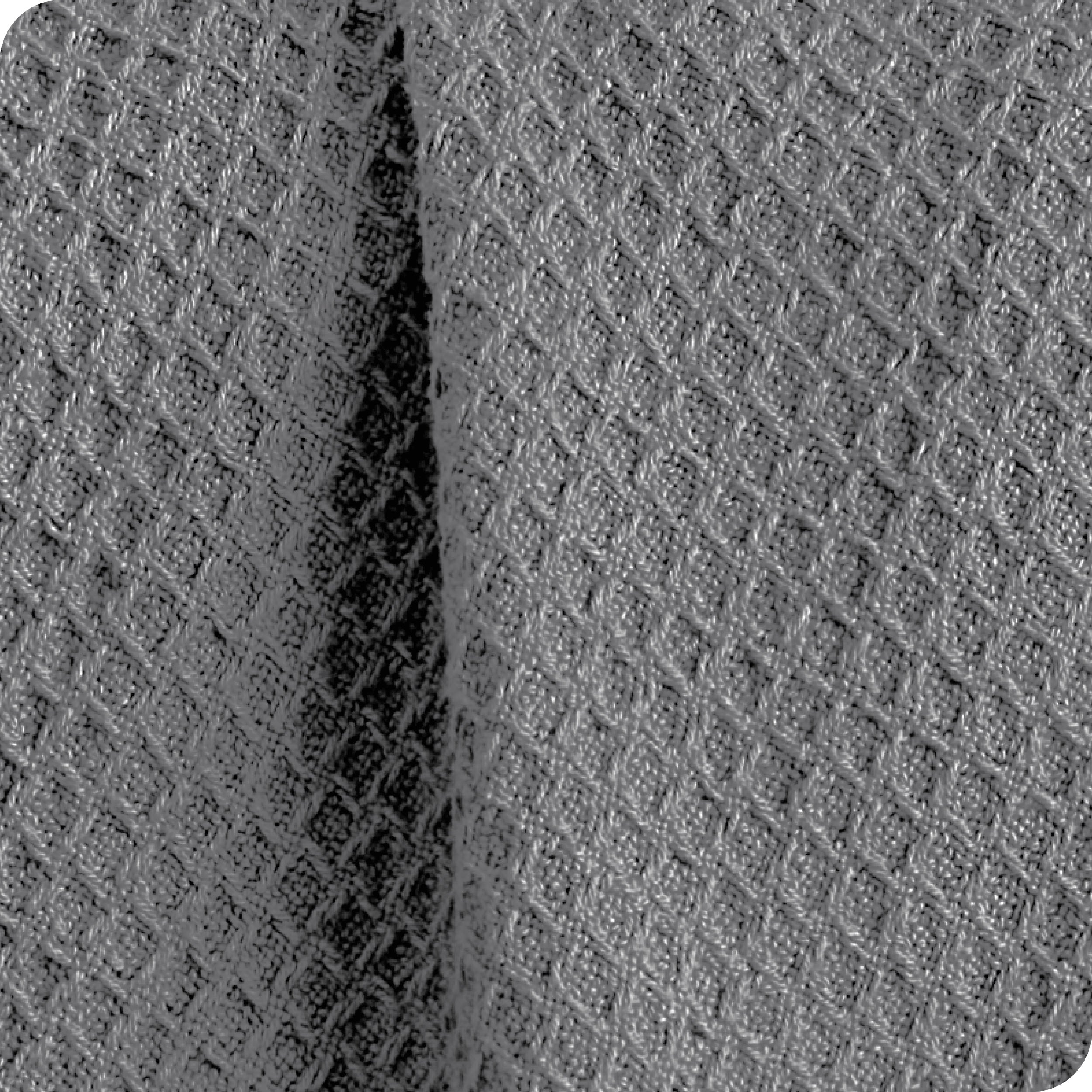 Close up of the fabric of a cotton waffle blanket