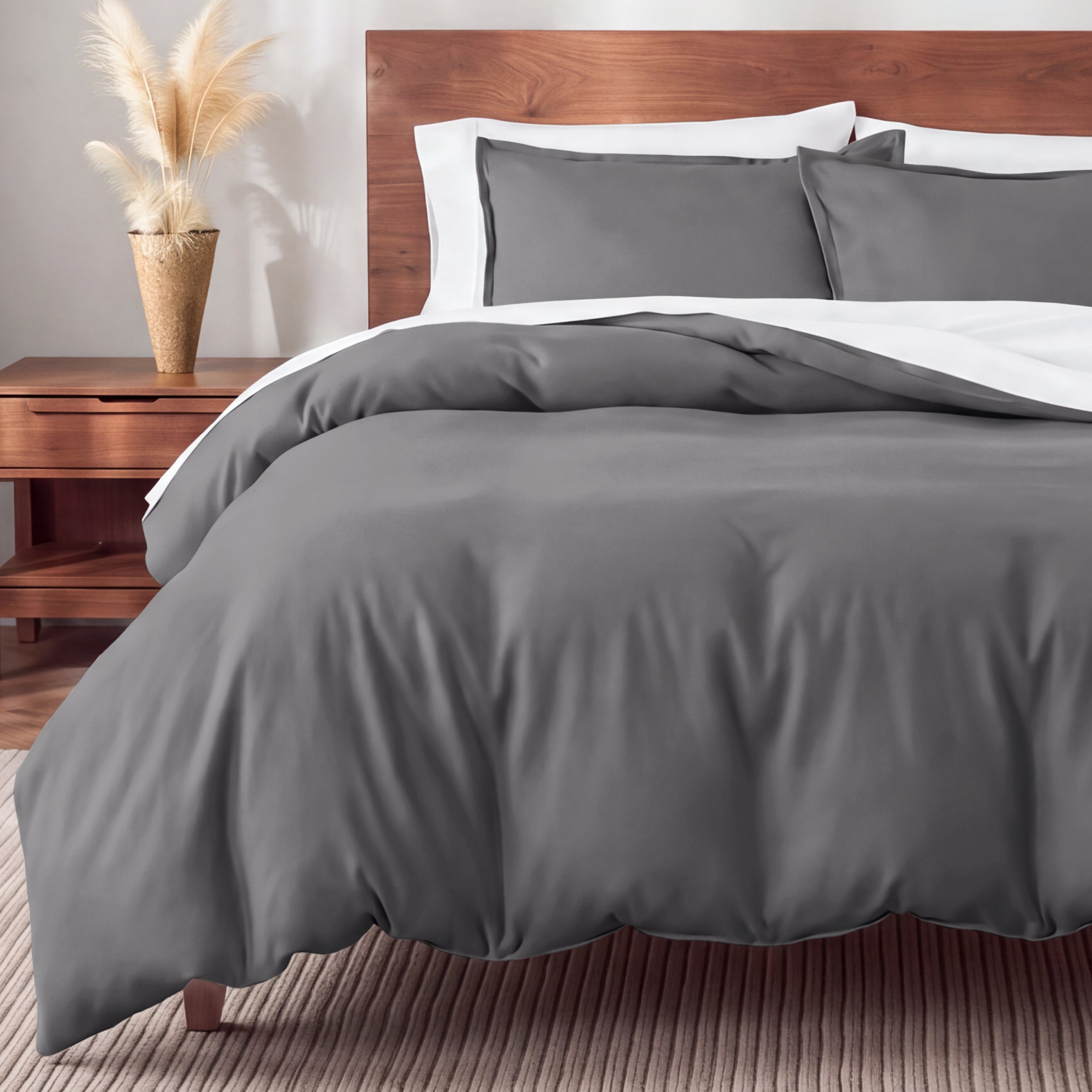 Flannel bedding set on a bed in a bedroom with a nightstand and lamp.
