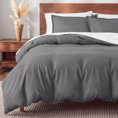 Flannel bedding set on a bed in a bedroom with a nightstand and lamp.