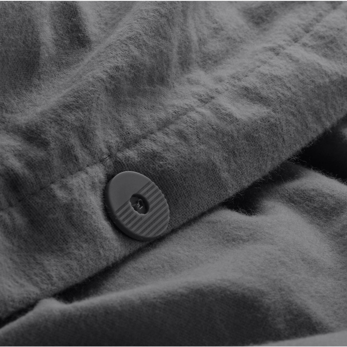 Close up of the button closure on a flannel duvet cover