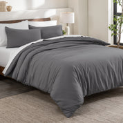 Flannel duvet cover set on a bed in a bedroom with a lamp and plant in the background.