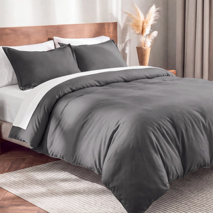 Flannel duvet cover set on a bed in a bedroom with a lamp and plant in the background.