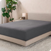 A modern bed with a flannel fitted sheet on