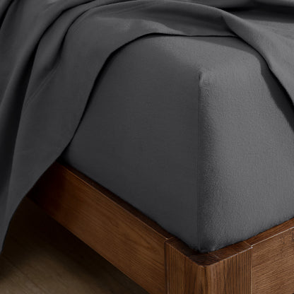 Flannel fitted sheet on a wooden bed frame