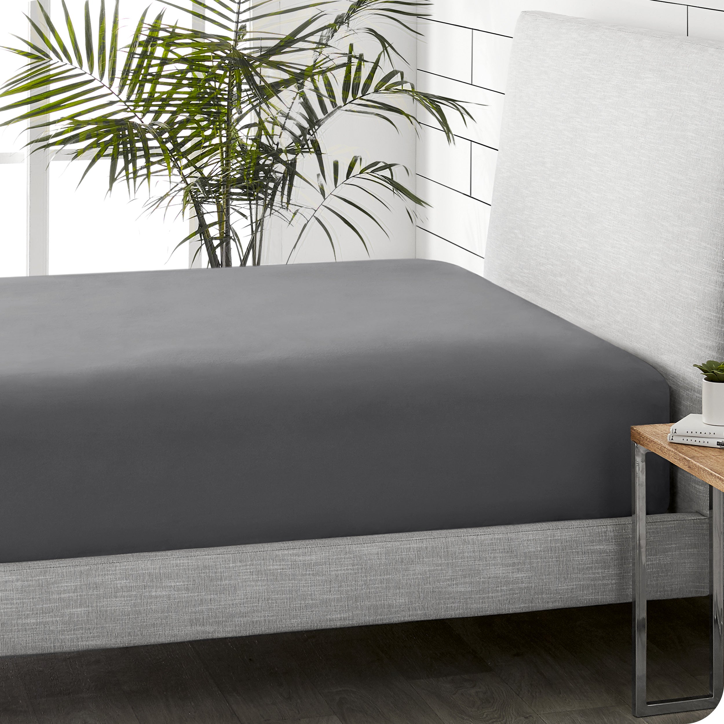 A sideview of a modern bed with a flannel fitted sheet.