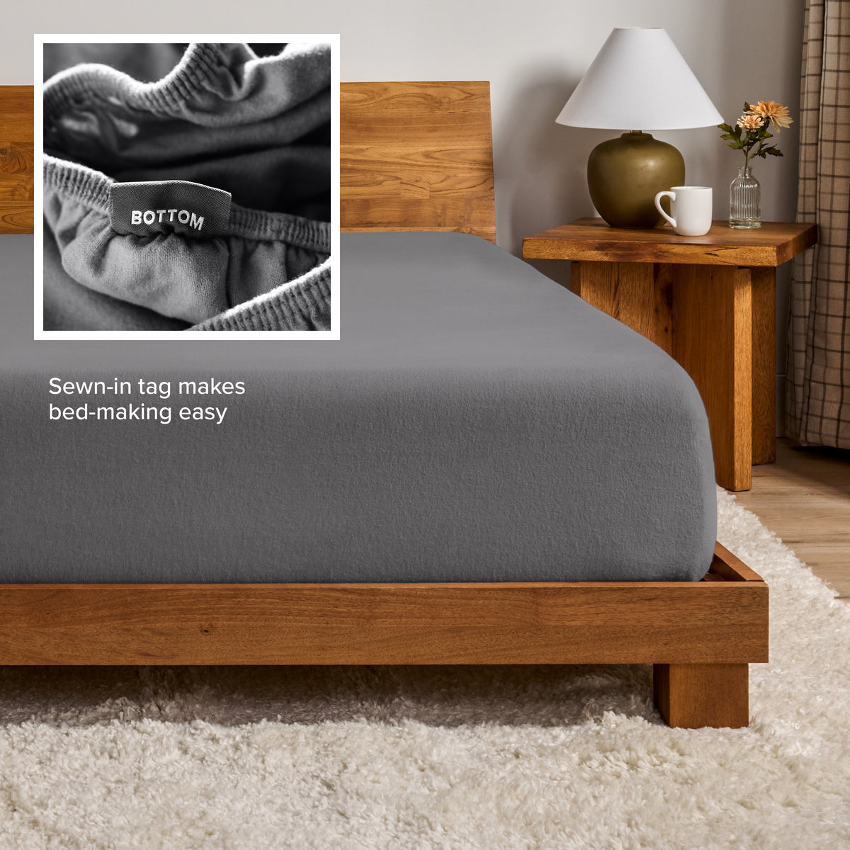 A flannel fitted sheet on a mattress with a wooden bed frame