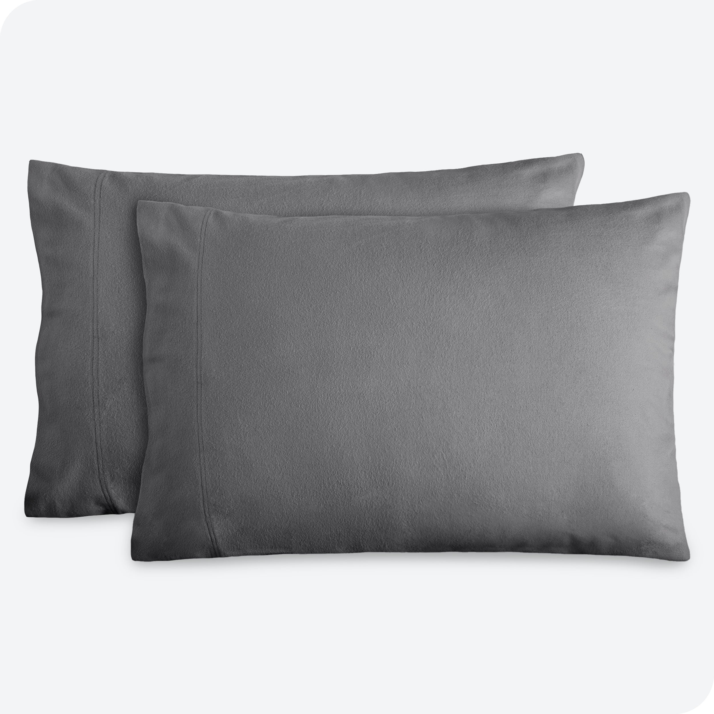 Two pillows with flannel pillowcases on them