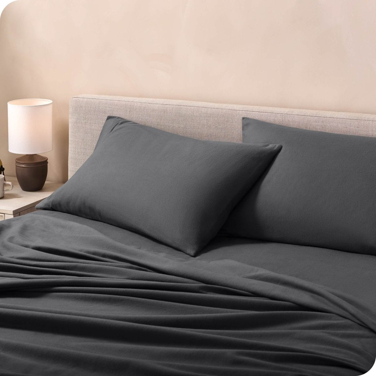 Flannel pillowcases on a mattress leaning against the headboard