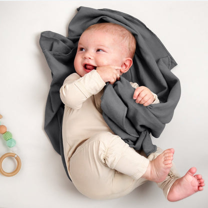 A baby lying on a flannel receiving blanket
