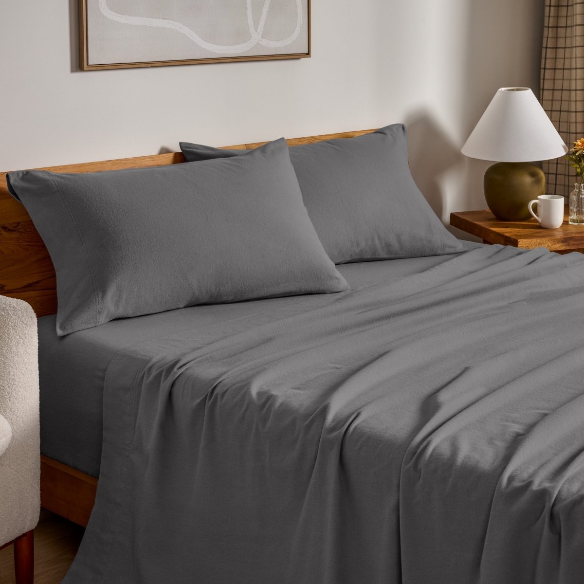 Flannel bed sheets and pillowcases on a bed in a bedroom setting.