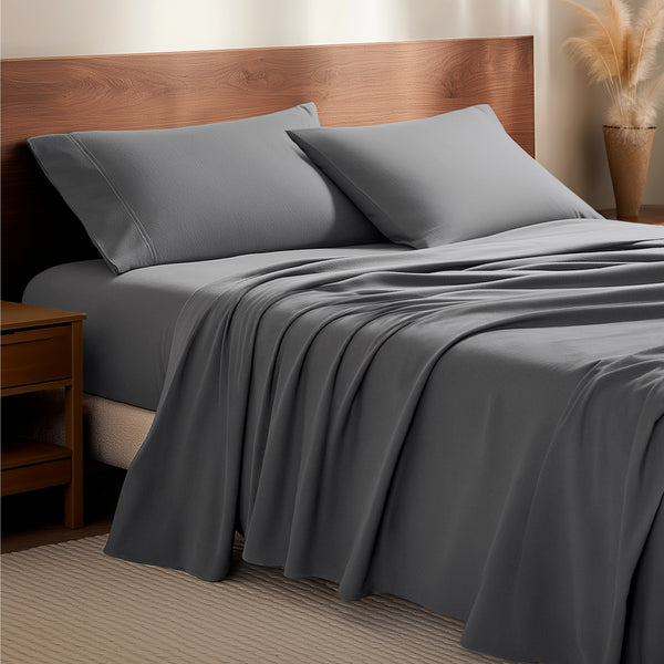 Flannel bedding set on a bed with a wooden headboard and side table