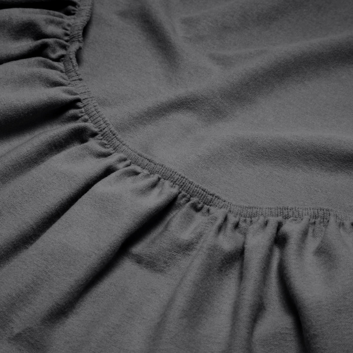 Close-up of a flannel fitted sheet with gathered elastic