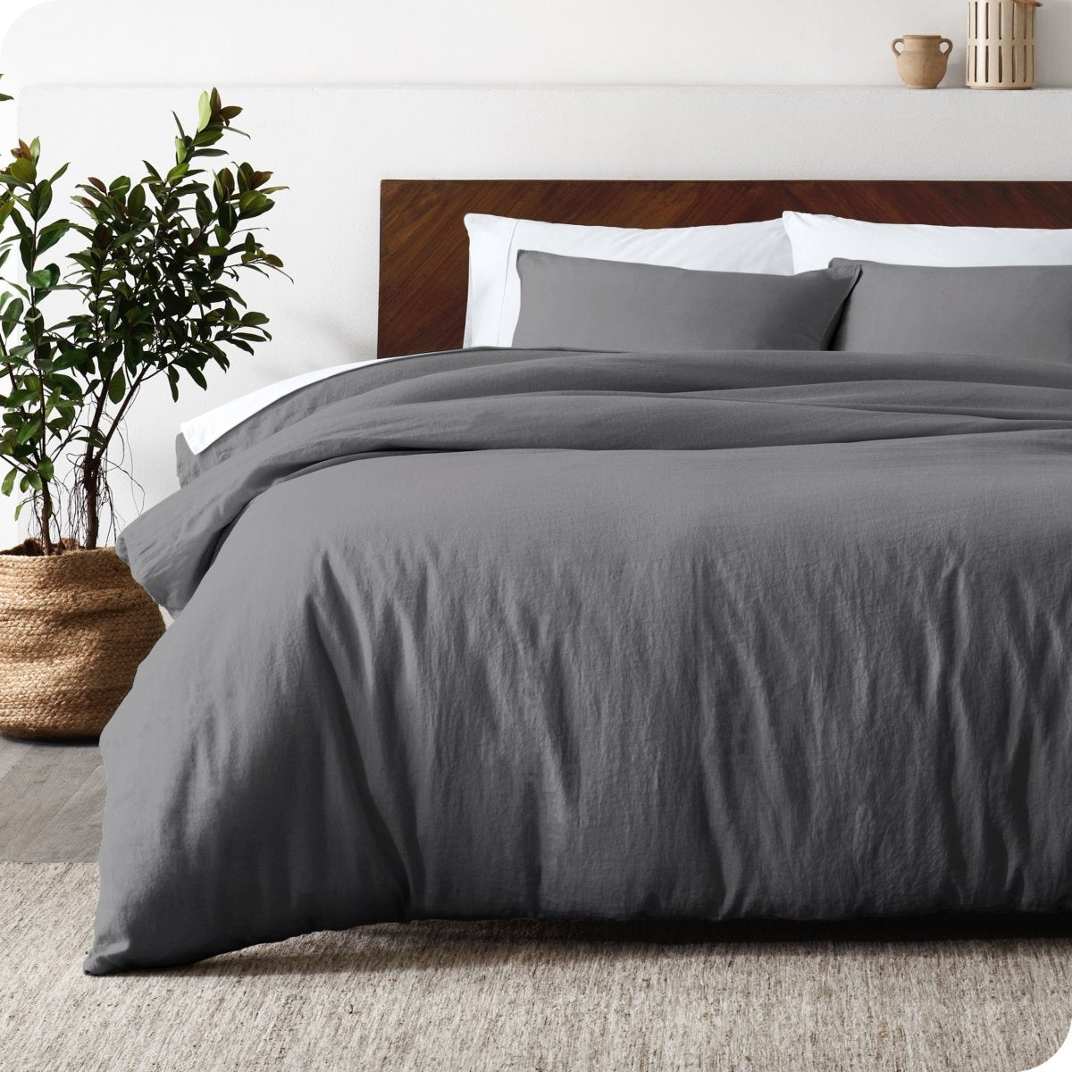 Relaxing room scene showing a grey linen duvet cover set laid out over the bed