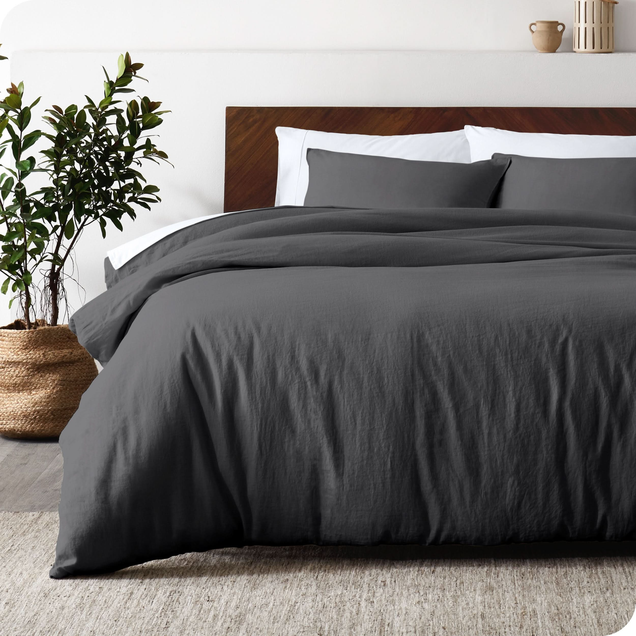 Relaxing room scene showing a grey linen duvet cover set laid out over the bed