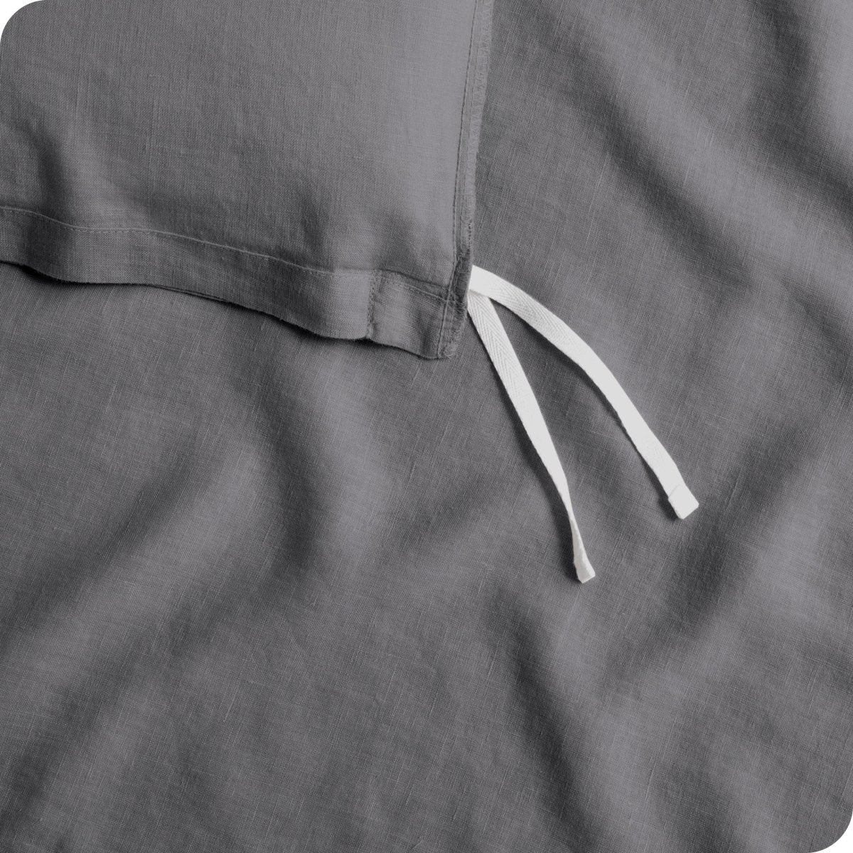 Close up of cloth tie straps for attaching duvet insert to inside of duvet cover