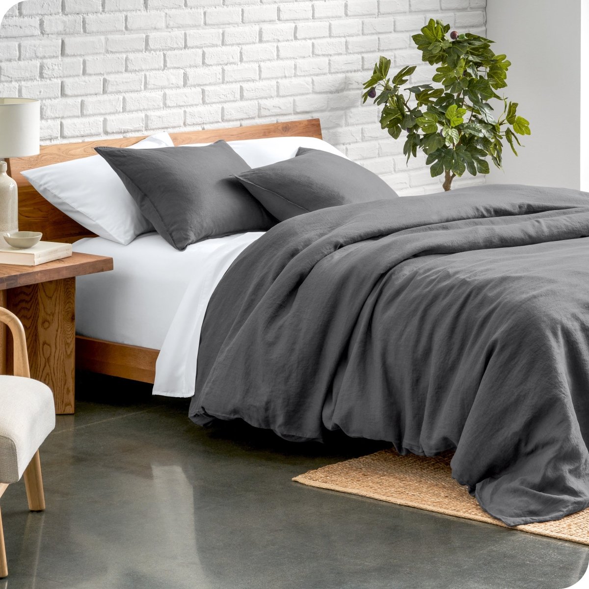 Relaxing room scene showing a grey linen duvet cover set laid out over the bed
