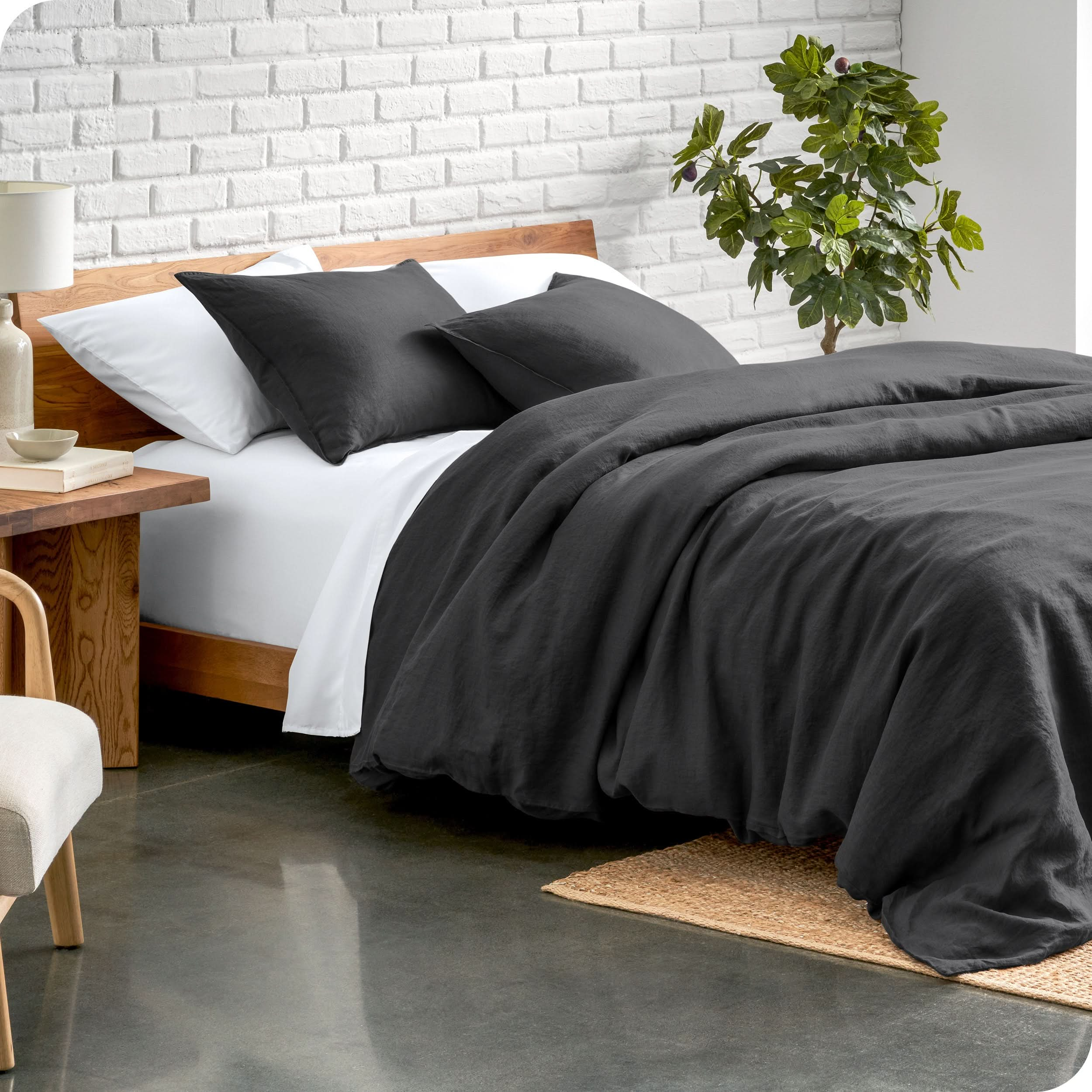 Relaxing room scene showing a grey linen duvet cover set laid out over the bed