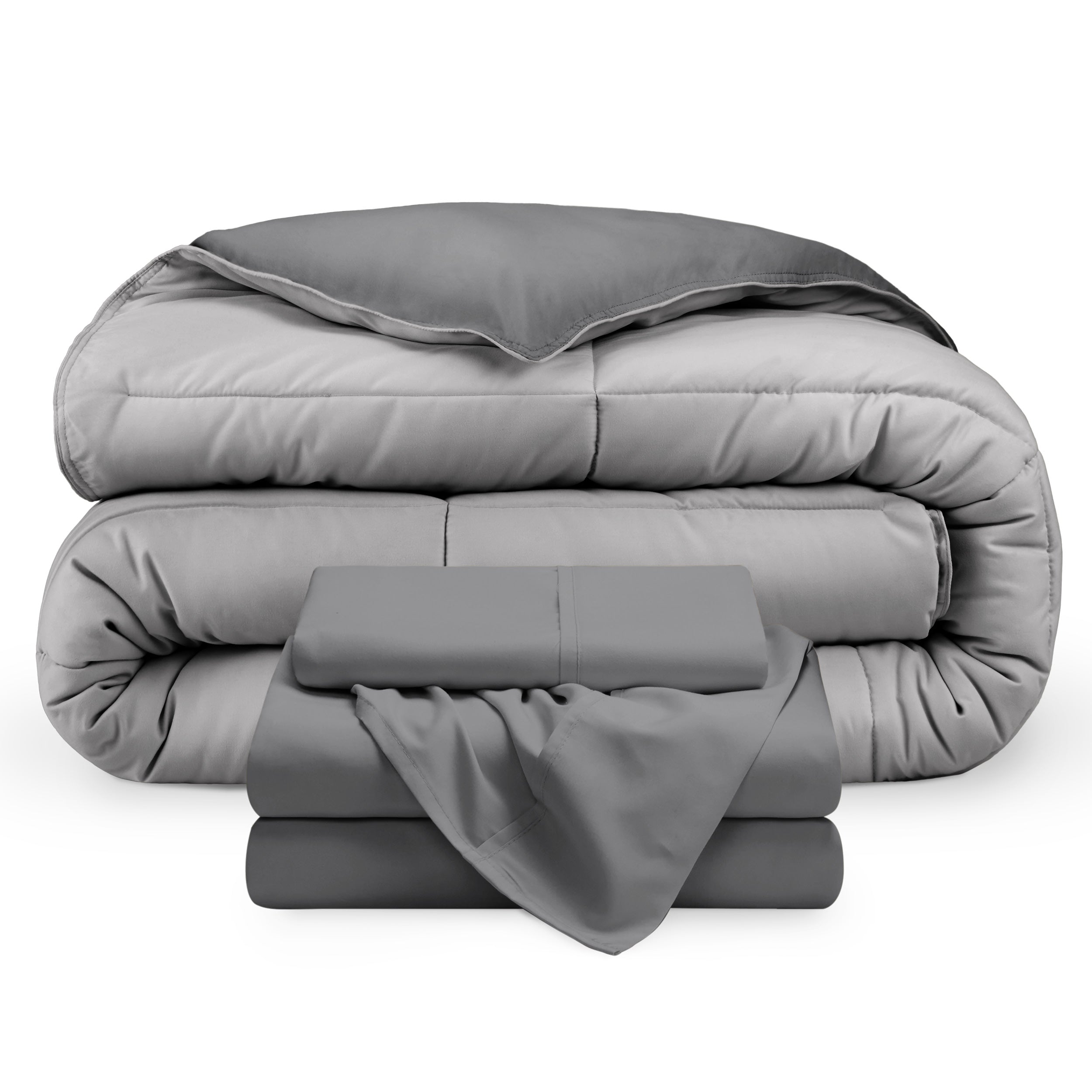 A reversible microfiber comforter and a coordinating sheet set folded and stacked 