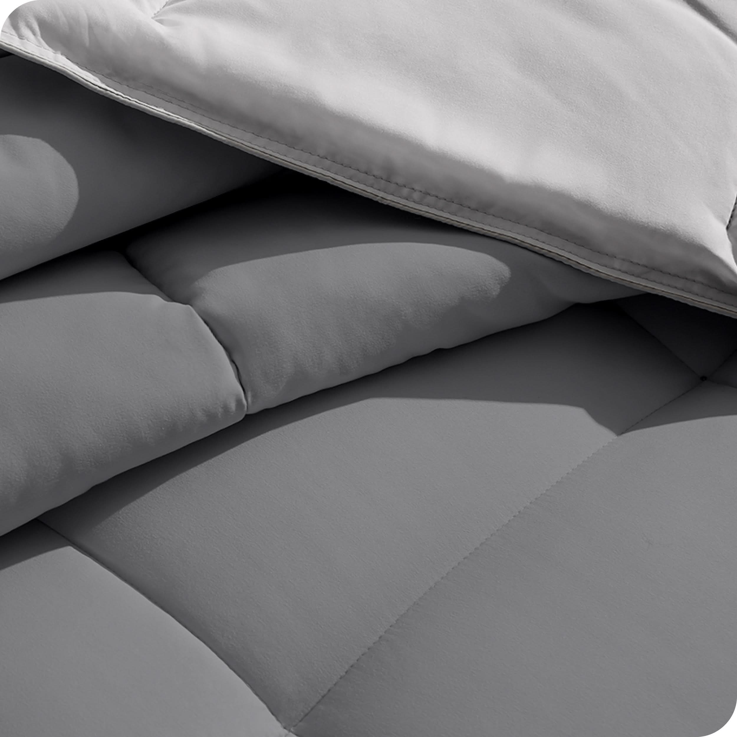 Close up of the reversible comforter showing the box stitching and the two colors