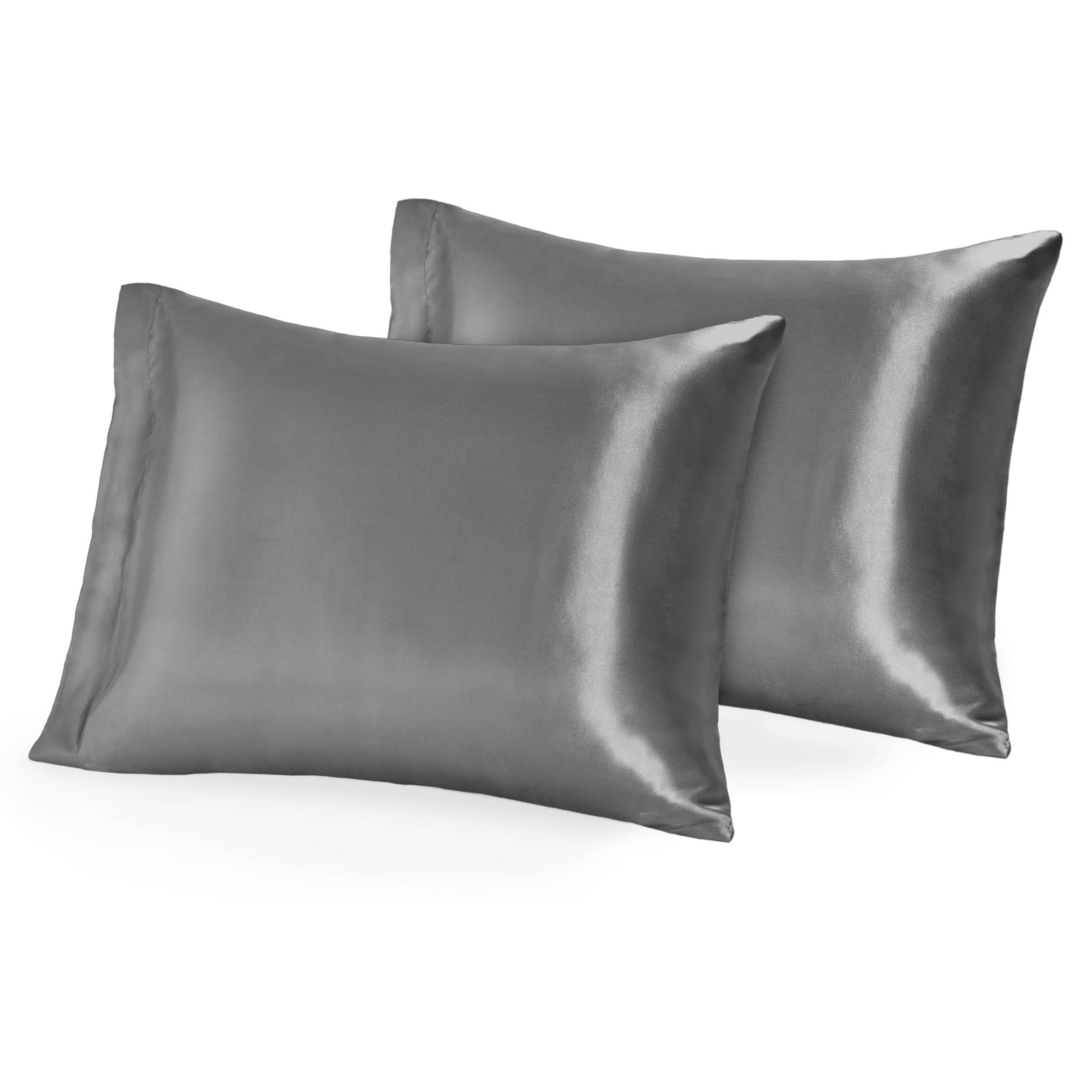 Two pillows topped with silk pillowcases
