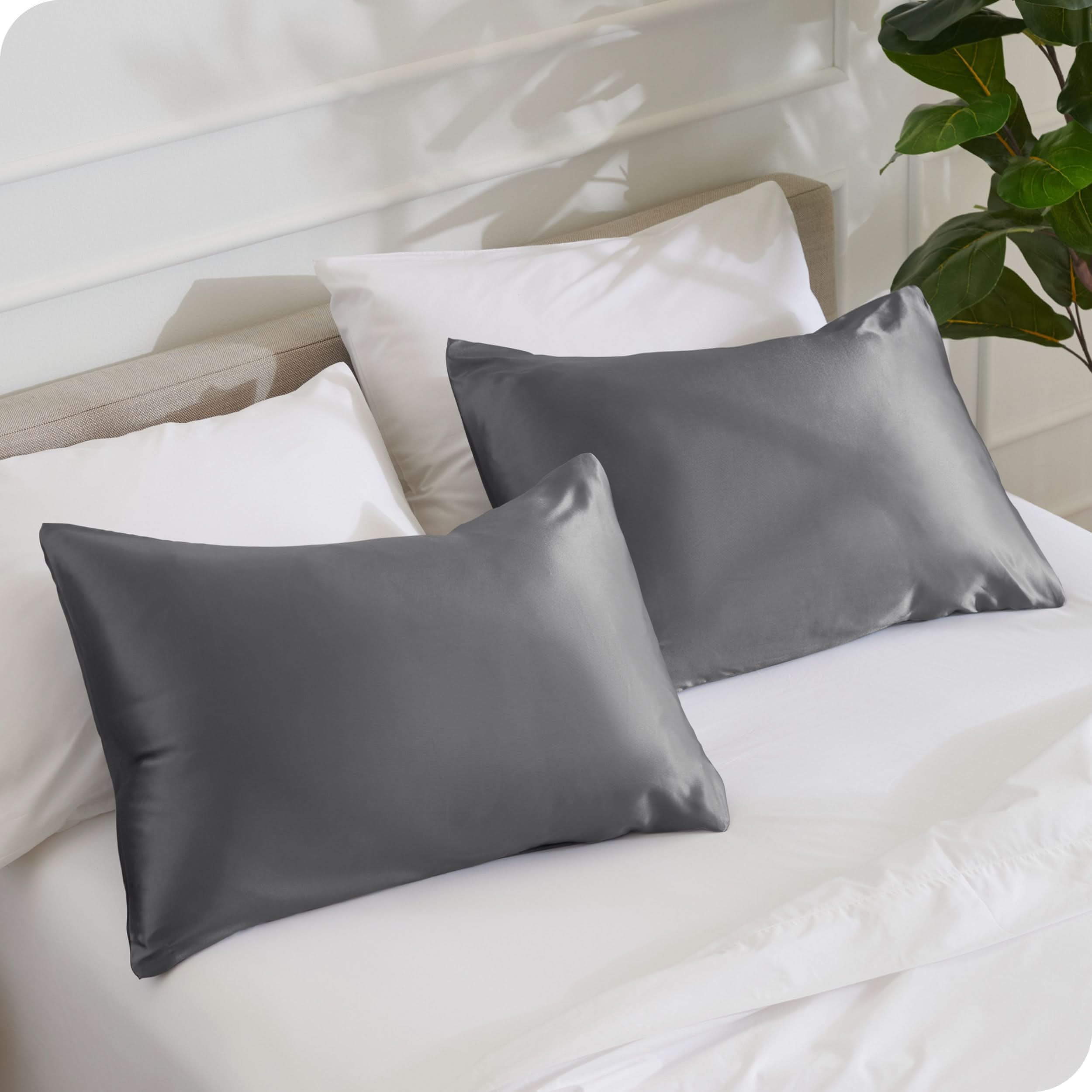 2 silk pillowcases on a bed with white linens