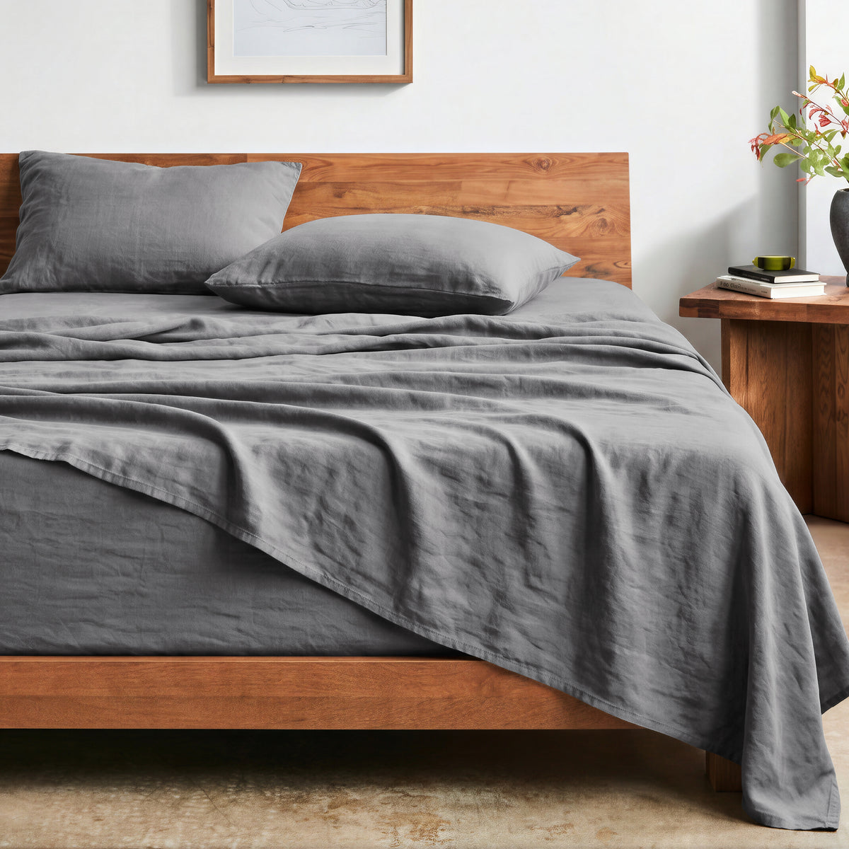 Bed with washed sheets and wooden headboard in a bedroom setting