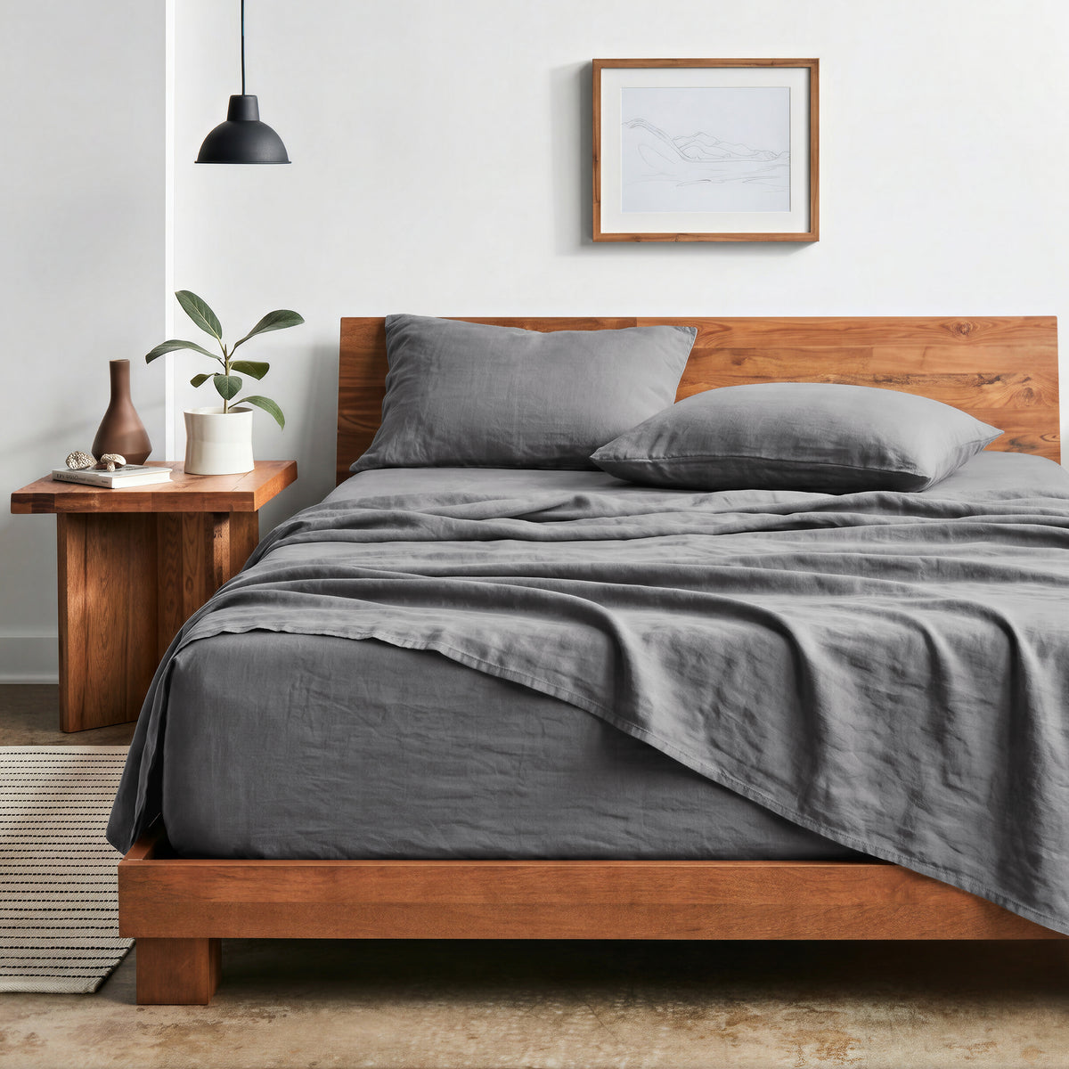 Bedroom with sheet set on a wooden bed frame and side table