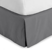 Bed skirt on a bed with white bedding