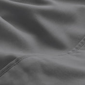A close-up of microfiber fabric with soft folds and a visible stitched seam.