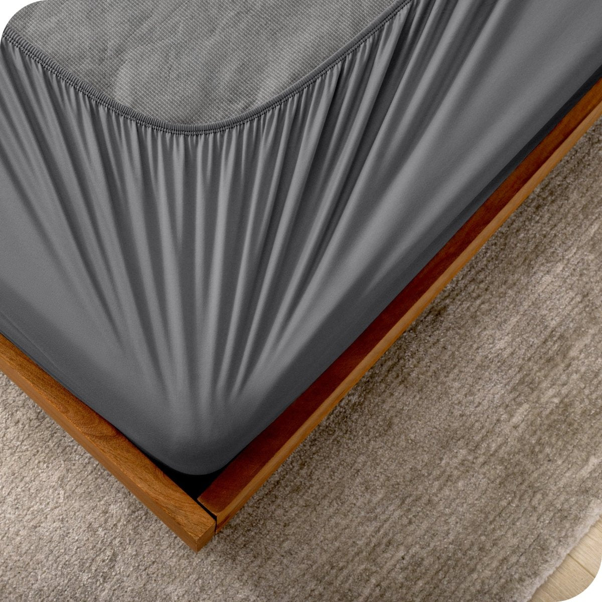The corner of a box spring with a cover on it
