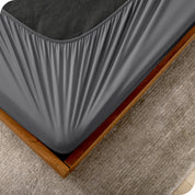 The corner of a box spring with a cover on it