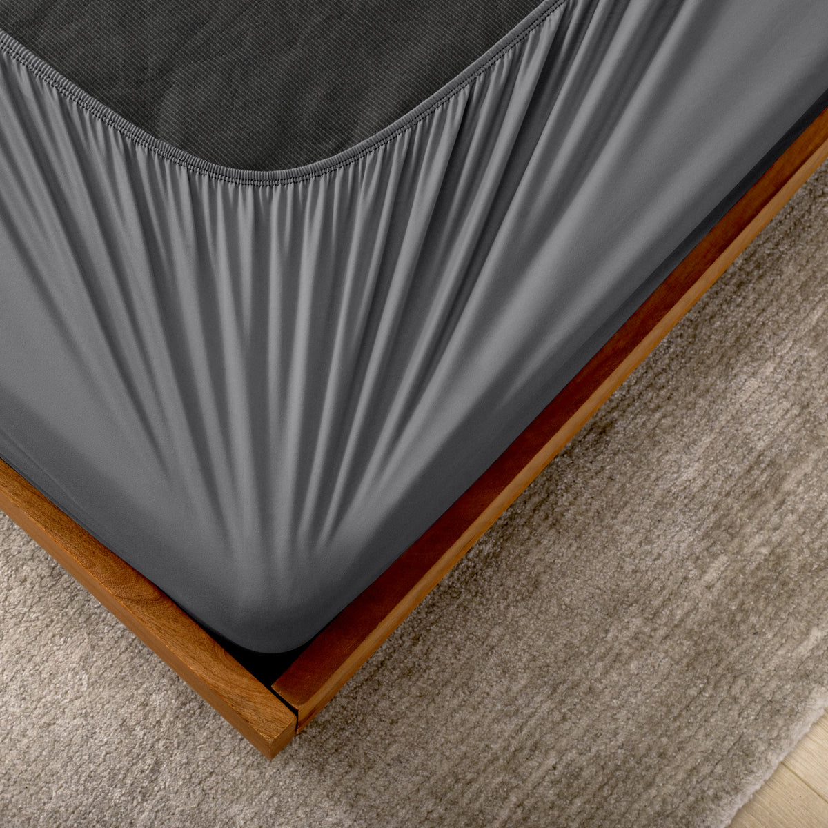The corner of a box spring with a cover on it