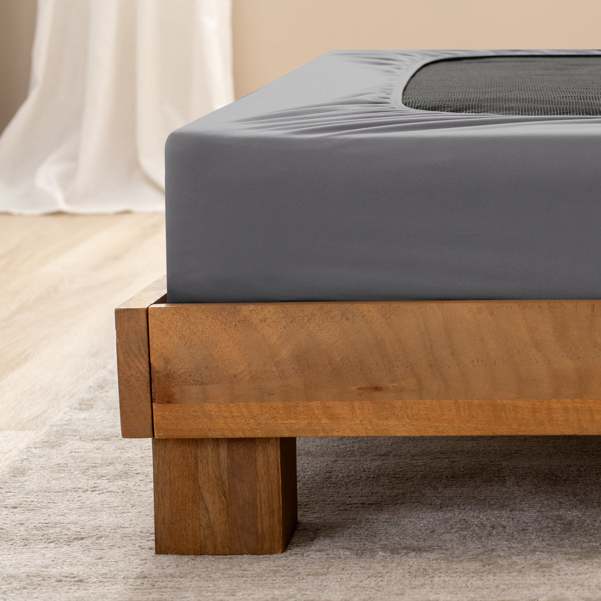 Close up of the corner of a bed frame with a cover box spring 